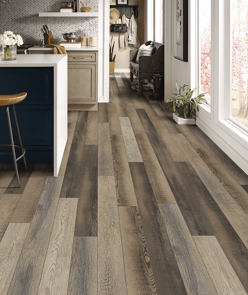 Close up view of luxury vinyl plank floors from Yoder Floors in a hallway leading from the mudroom to the kitchen seamlessly