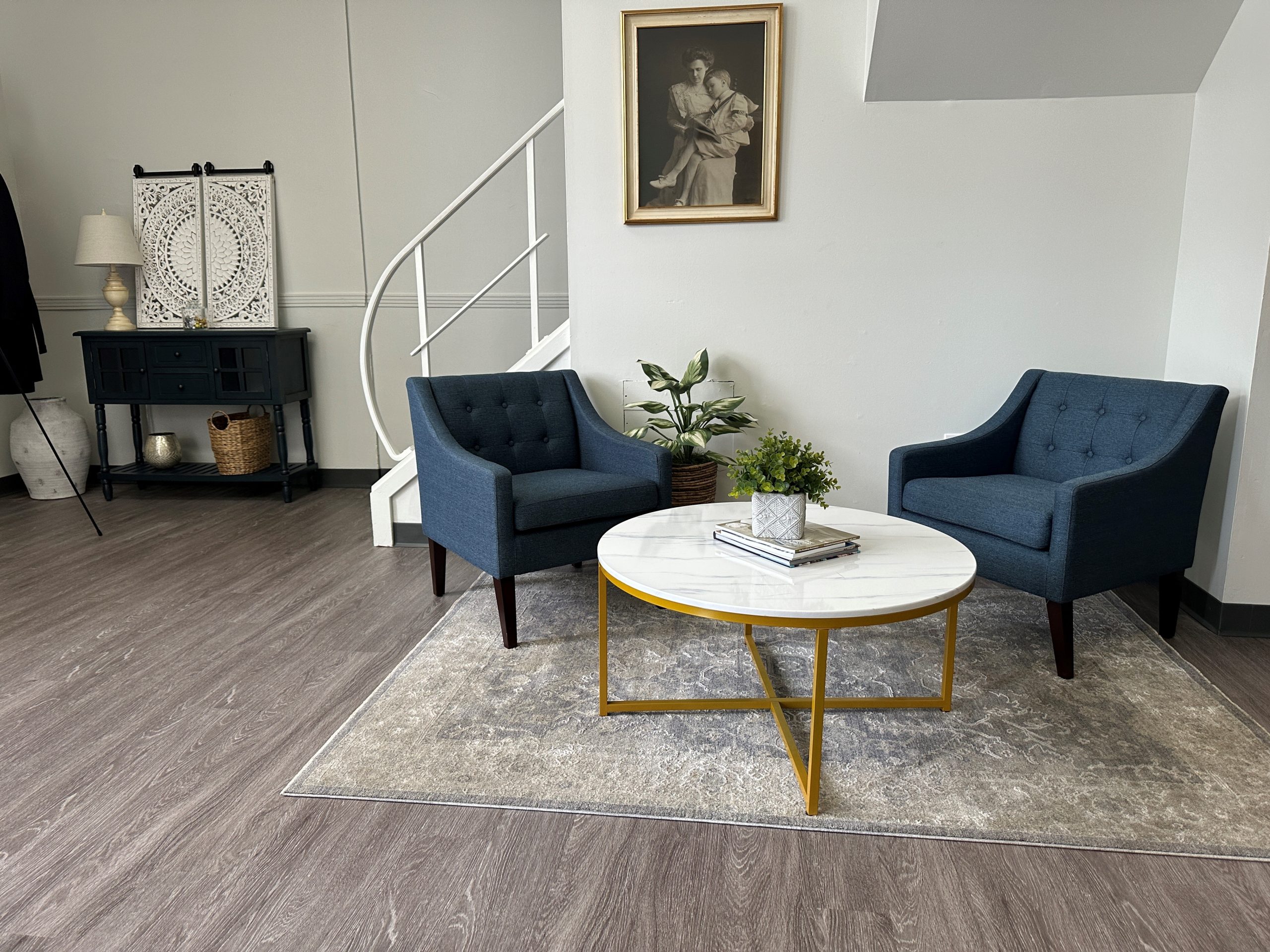 Breathing association 3 Gray LVP flooring Yoder Floors in a medical office waiting area furnished with two chairs and a coffee table, while a pale gray custom rug.