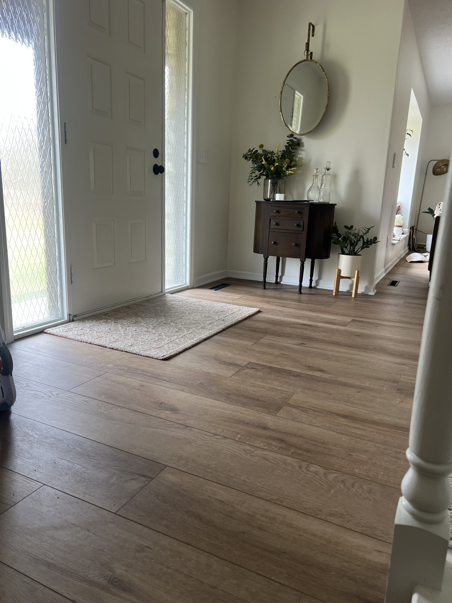 A heavy-duty doormat in a home entryway, protecting hardwood floors from outdoor dirt and moisture.