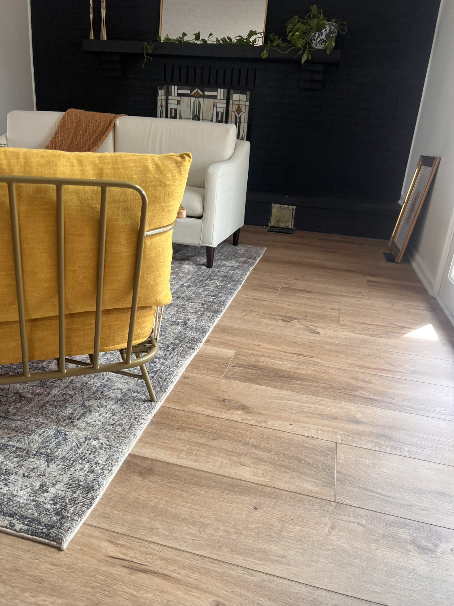 Copy of IMG_4587 Close up of LVP floors and custom area rug in a sunlit Columbus, Ohio living room.