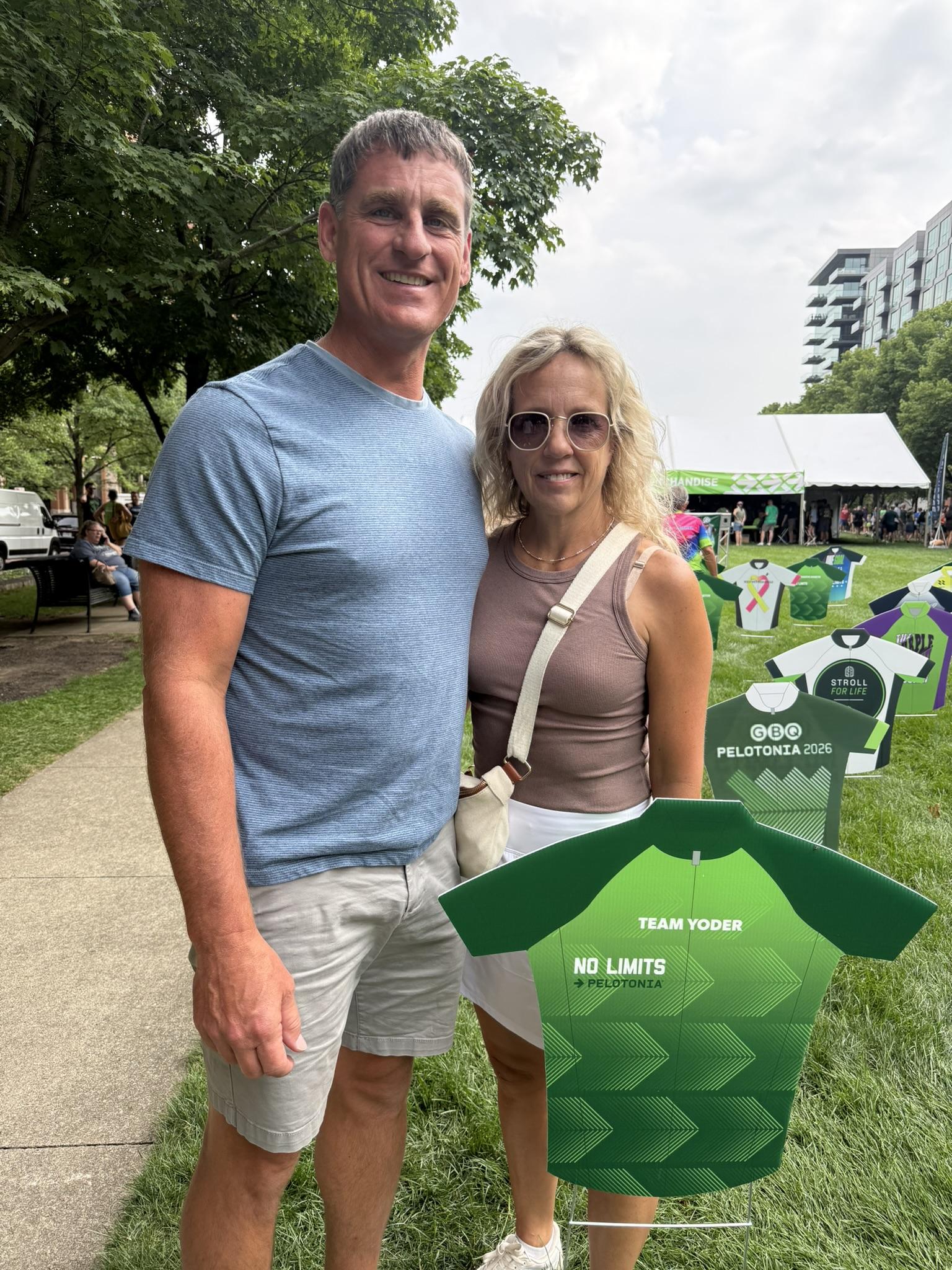 Sheldon and Julie at Pelotonia opening ceremonies next to the Team Yoder No Limits jersey.