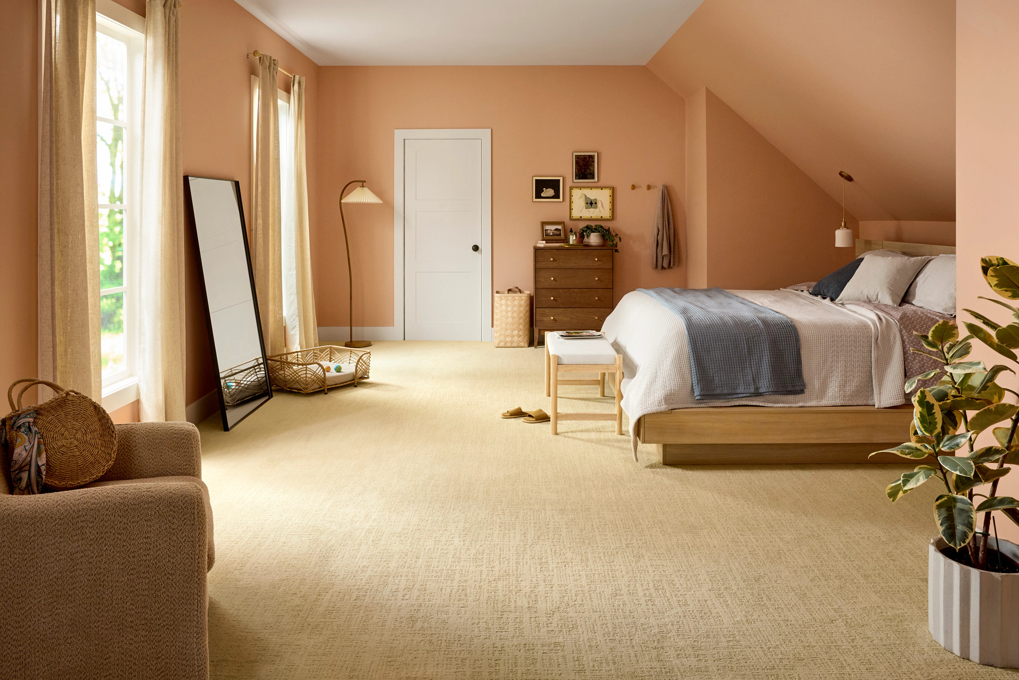 5E932_102_Bedroom_Wide A soft, textured carpet in warm cream sets the tone for this cottagecore bedroom, paired with linen curtains, light wood furniture, and a rattan pet bed that keeps the room cozy and practical at the same time.